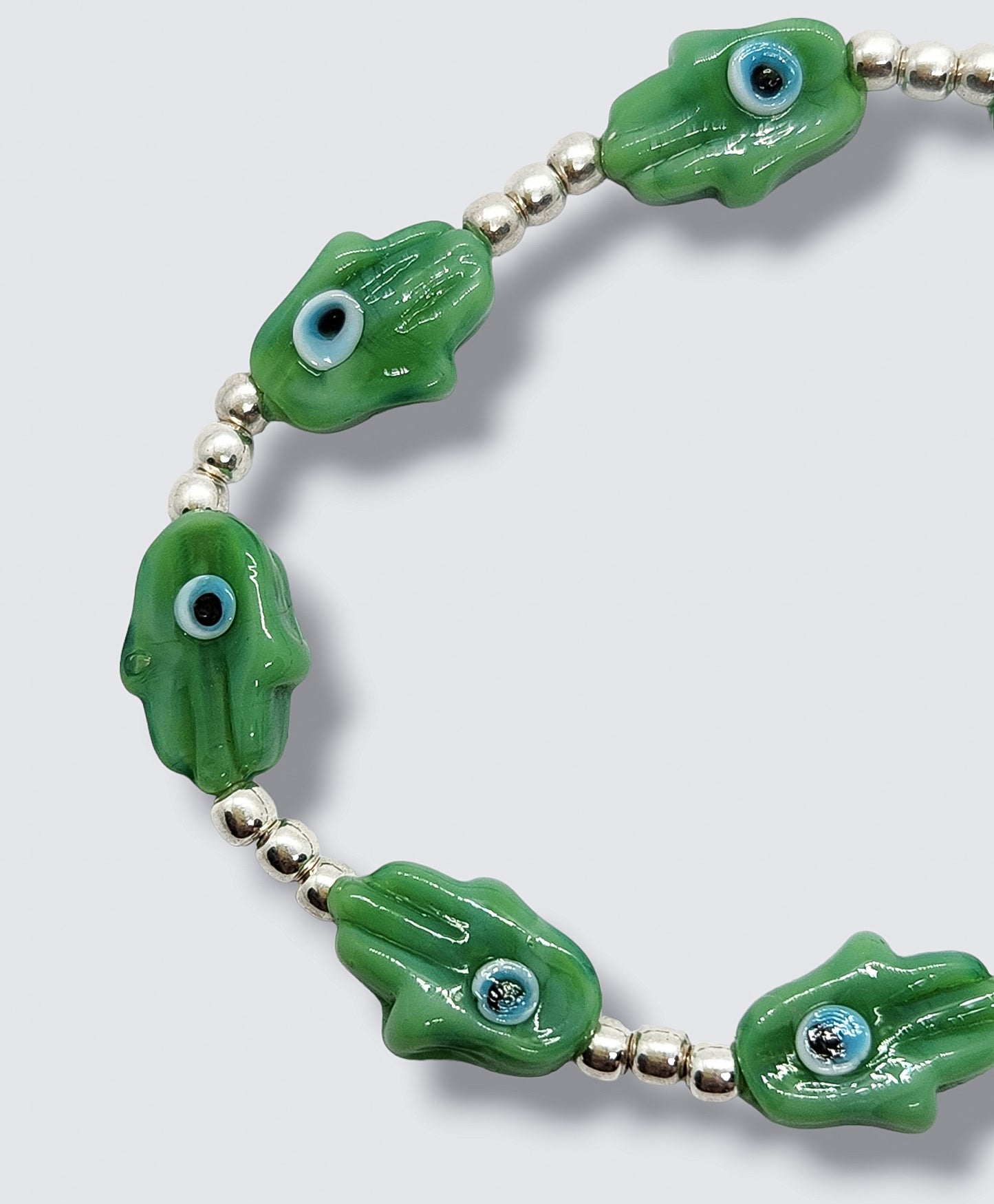 Pulsera de bolitas de plata con mano de fátima y ojito turco VERDE